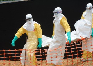 Dokters Sonder Grense neem 'n ebola-slagoffer in Guinee weg Foto: thewestsidestory.net