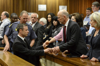 Oscar Pistorius word na die aanhoudingselle by die hooggeregshof in Pretoria geneem nadat hy op 21 Oktober 2014 tot vyf jaar tronkstraf gevonnis is op aanklag van strafbare manslag. Foto: Herman Verwey/Media24/Pool