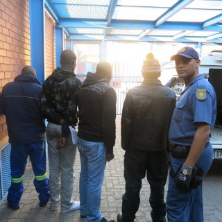 Konstabel Neil Jacobs van die Kimberley-polisie by die vier verdagtes Foto: SAPD, verskaf 