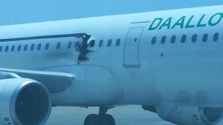 (160203) -- MOGADISHU, Feb. 3, 2016 (Xinhua) -- Photo taken on Feb. 2, 2016 shows the damage caused by an explosion on an aircraft after its emergency landing at Mogadishu's international airport, Somalia. A plane belonging to Daallo Airlines made an emergency landing in Mogadishu on Tuesday after it caught fire a few minutes after it took off, injuring two people, officials said. (Xinhua/Abdi)(zhf)