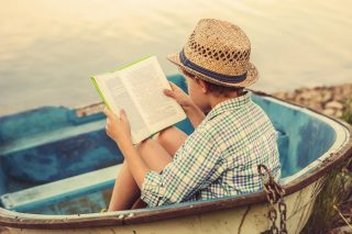 boy-reading-in-boat